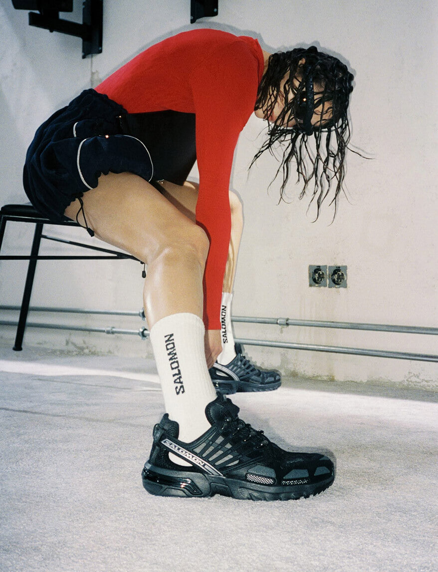 Up There campaign image showing a model wearing Salomon sneakers